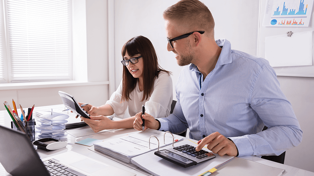 2 accountants happily working in an office setup