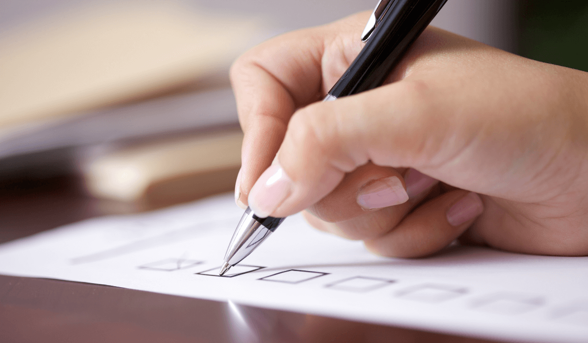 A view of a hand checking the tax list