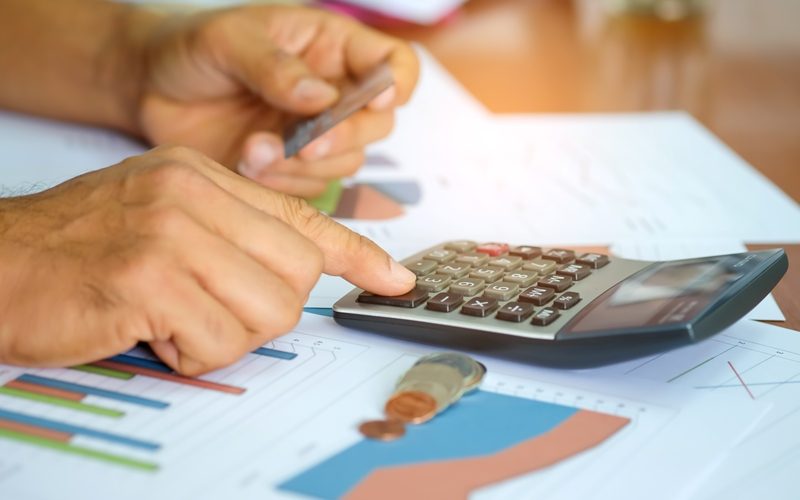 A view of hands on a calculator