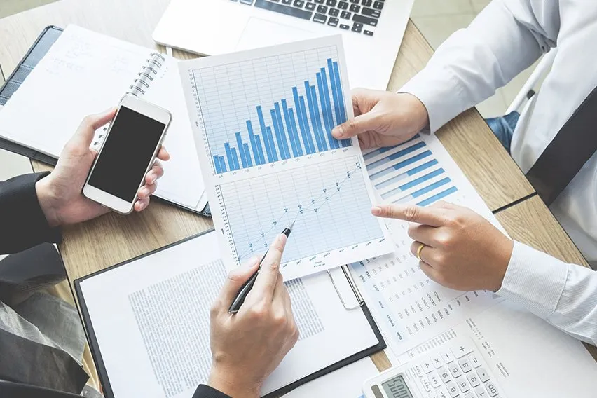 People reviewing financial charts and graphs.