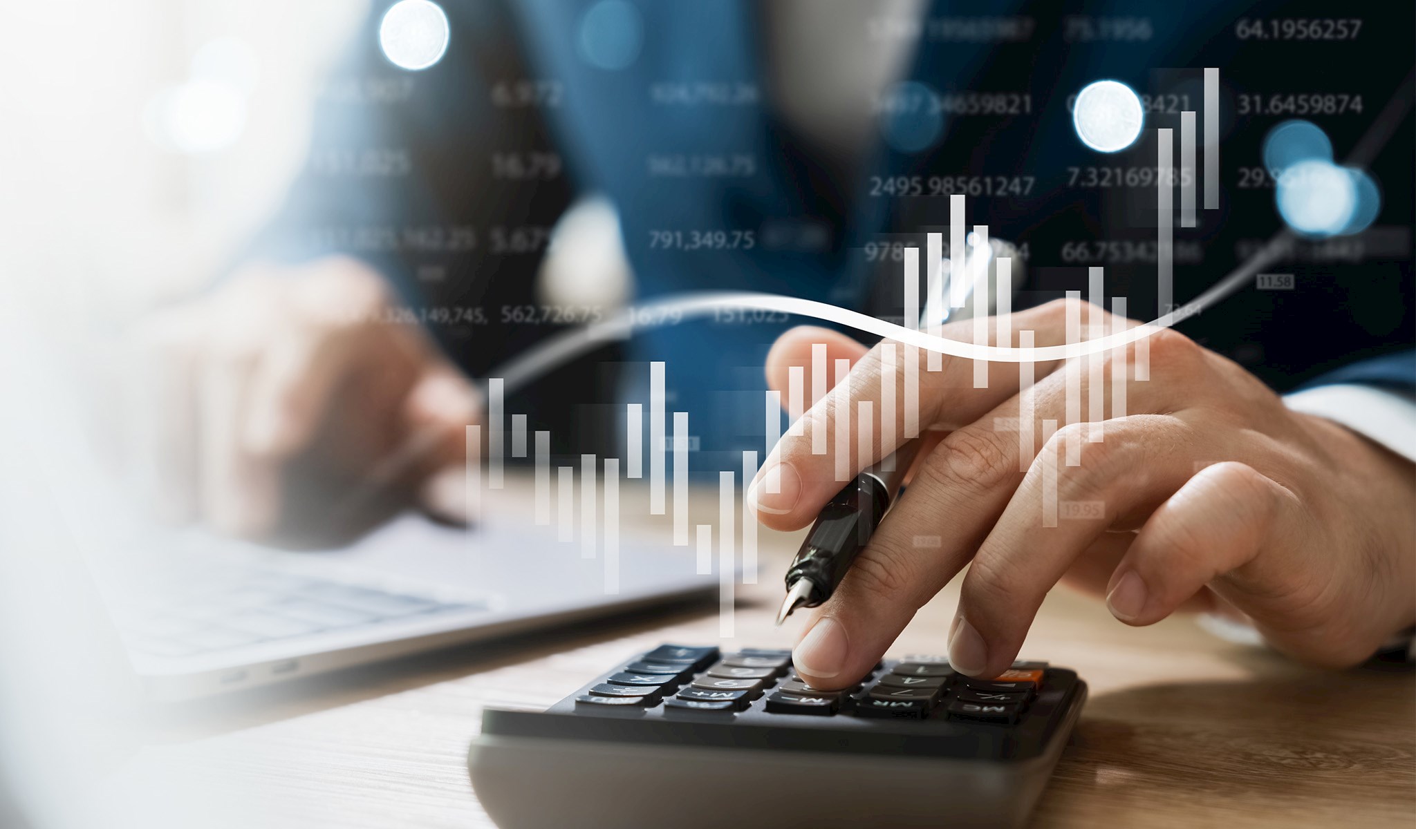 Person using a calculator with financial graphs overlayed